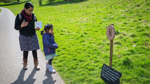An adult and child reach the next part of the Easter trail at Dyrham Park, Gloucestershire